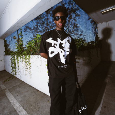 Original SYNOTACY graphic tee worn outdoors in the archive campaign